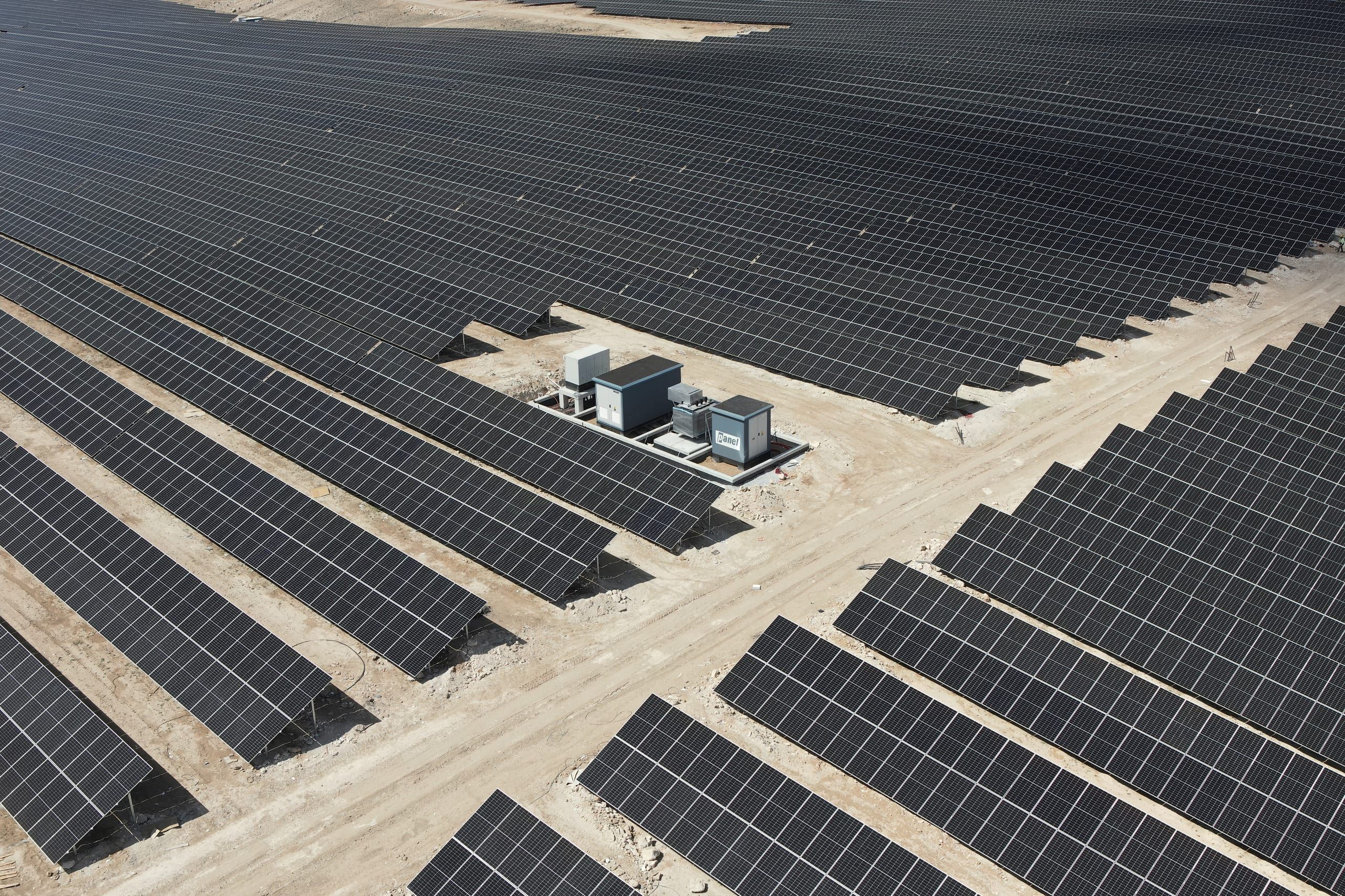 Aerial view of a Panel Elektrik transformer kiosk installed between photovoltaic arrays at a solar power plant